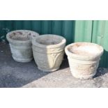 Three composite stone circular garden planters or pots
