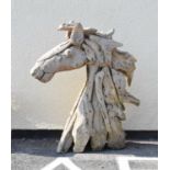 Modern driftwood garden sculpture in the form of a horses head