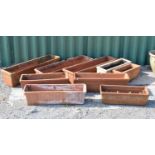 Nine rectangular terracotta troughs or planters