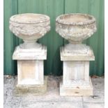 Pair of composition garden urns and pedestals