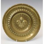 Nuremberg-type brass sheet alms dish with central fleur-de-lis