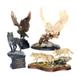 Four resin models of owls, wolves, etc