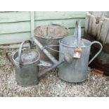 Small group of galvanised garden items including two watering cans