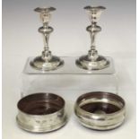 Pair of George V dwarf silver candlesticks together with two Elizabeth II wine coasters