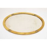 Arts & Crafts brass framed oval beveled mirror