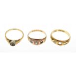 Three gold rings comprising an 18ct gold gypsy set ring
