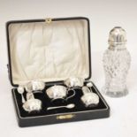 Cased silver condiment set, together with a George V silver-topped cut-glass sugar shaker