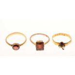 Three red stone set rings