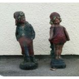Painted composite stone figures of a boy and girl