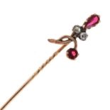 A rose diamond and red paste set stick pin