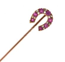 A diamond and ruby horseshoe stick pin