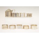 Edward VII silver mustard pot, and seven silver napkin rings