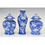 Chinese blue and white porcelain garniture of three prunus decorated vases