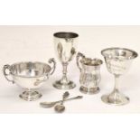 Three silver trophy cups, a Victorian silver christening mug, and two white-metal spoons