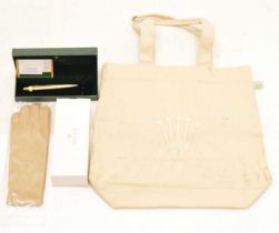 Rolex - Gilt metal retractable ballpoint pen, pair of dealers gloved and tote bag