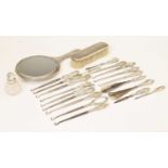 Assorted silver-handled dressing table items, including button hooks, hand mirror, hair brush etc