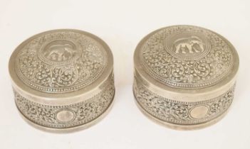 Pair of Indian white-metal circular boxes with typical foliate and elephant kutch decoration