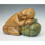 Carved wooden figure of a sleeping child/monk
