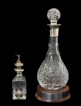 Elizabeth II silver collared Hogget/Hoggit decanter, together with silver capped small decanter