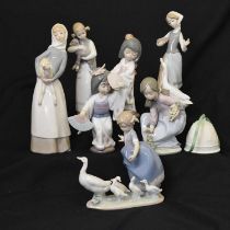 Lladro - Seven porcelain figures and Christmas bell
