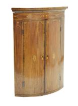 George III inlaid mahogany bowfront corner cupboard