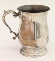 Elizabeth II silver mug of bellied footed form with scroll handle