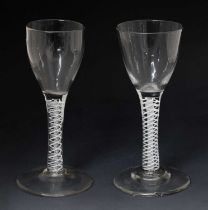 Two similar opaque twist stem wine or cordial glasses