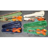 Four cased violins to include vintage examples