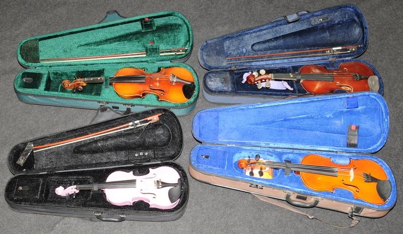 Four cased violins