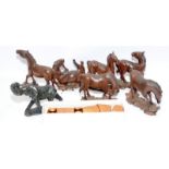 Collection of small wooden carved horse figures together with a boxed set of wooden napkin rings and