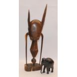 Tribal art hardwood abstract figure c/w hardwood carved elephant. Figure 51cms tall