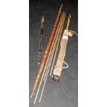 Collection of tribal bow and arrows and short handled spear