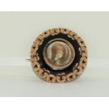 Gold Mourning brooch set with black jet and scrolled decoration inscribed 1881 with gold on inside