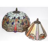 Two coloured lampshades in the Tiffany style. The largest is 30cms across