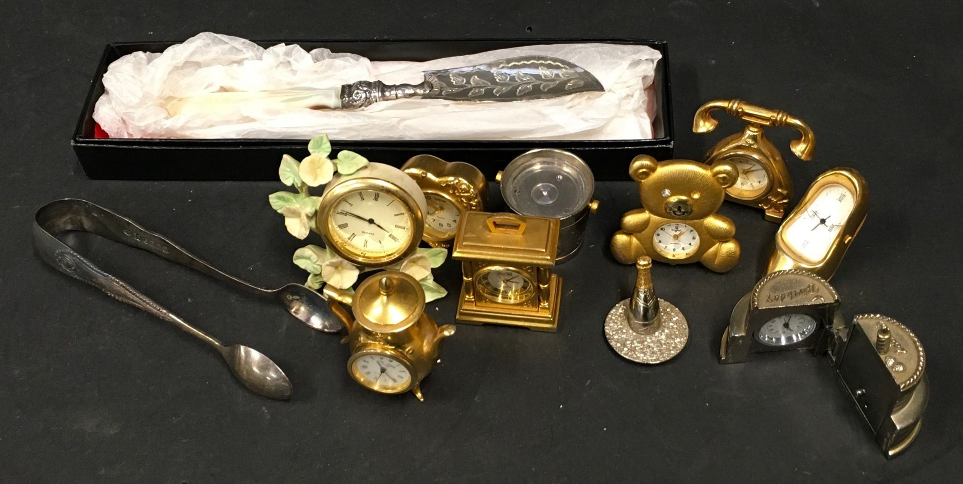 Miniature clocks (9) silver scoop, and pair sugar nips