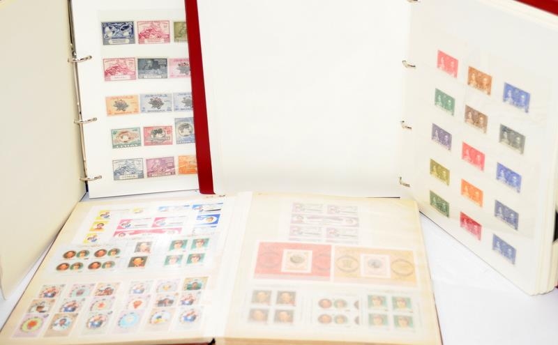 Three stamp albums to include QEII Coronation Omnibus, a stock book of unused world stamps
