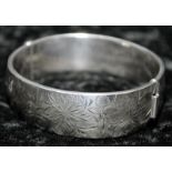 Sterling silver bangle with engraved floral decoration. Hallmarked Birmingham 1967