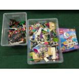 Two boxes of Lego, one containing Lego Friends pieces with figures.