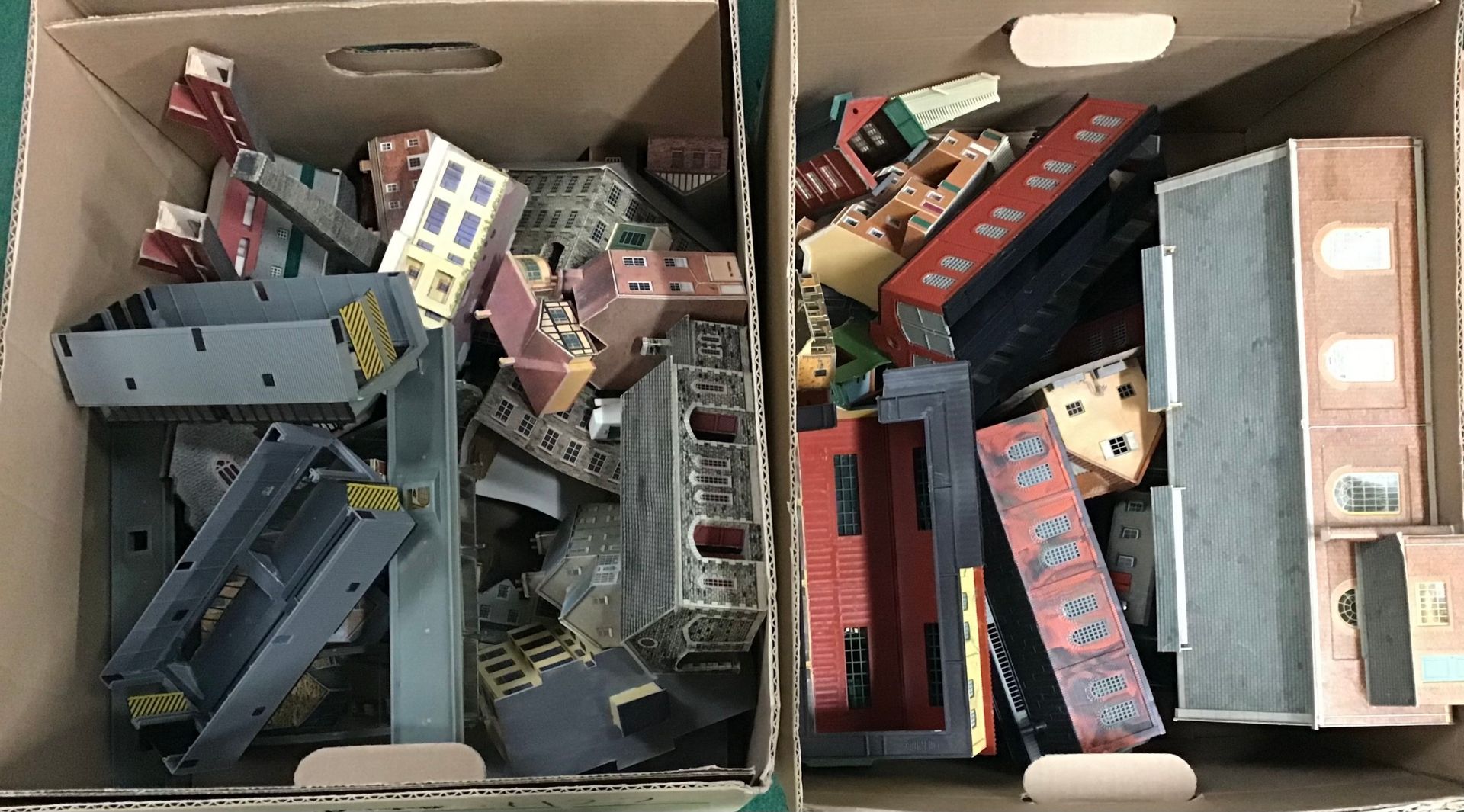 Two boxes of N Gauge plastic and card buildings.