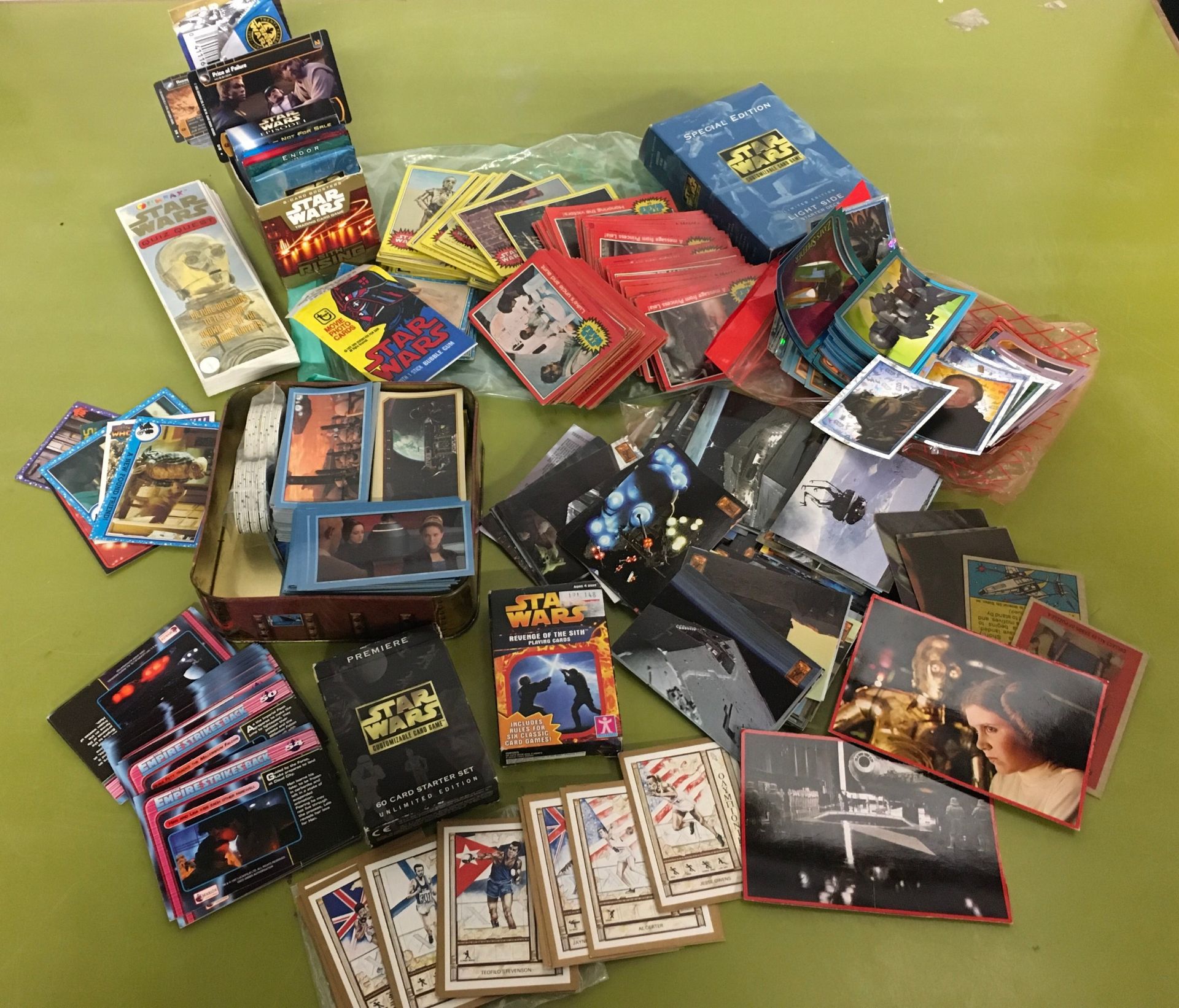 Collection of Star Wars collector cards and games cards.