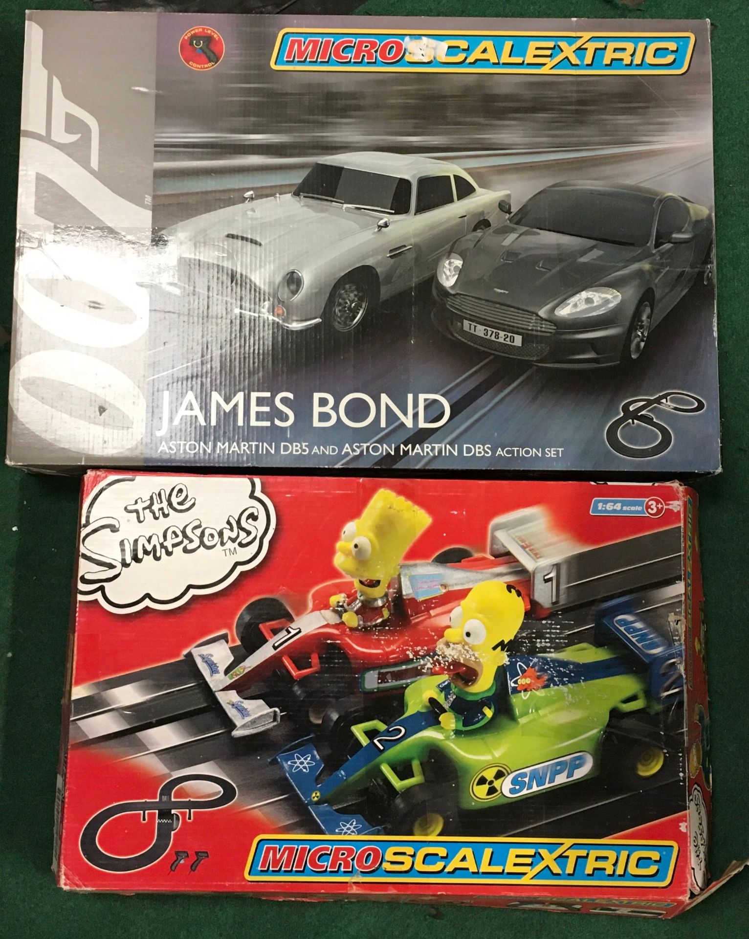 2 x Micro Scalextric sets: James Bond Aston Martin set and The Simpsons (one car missing). Both seem