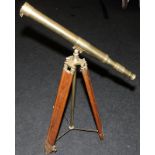 Large brass telescope on adjustable brass and wood tripod base. O/all length of telescope 73cms