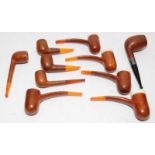 Collection of vintage briar pipes with amber mouthpieces, includes a silver collar example and a