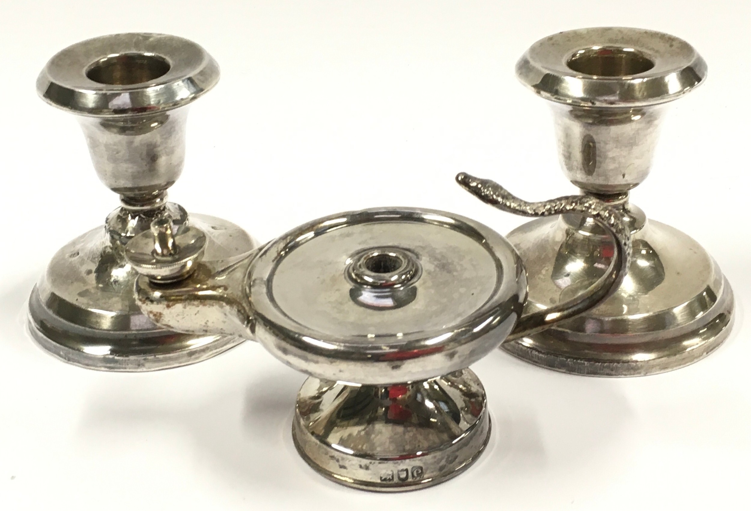 Pair of silver hallmarked squat candlesticks together with a silver hallmarked oil lamp.