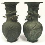 Pair of antique cast metal oriental vases with stamped marks to bases. Each measures 26cm tall.