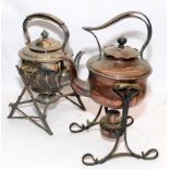 Two antique spirit kettles on stands c/w original burners. One copper and the other is silver