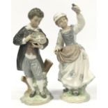 Two Lladro figurines of a boy with flowers and a girl with a bird.