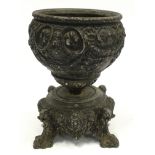 Antique cast metal urn 22cm tall.
