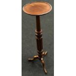 Antique dark oak torchere resting on three legs with carved decoration 99cm tall.