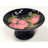 Moorcroft magnolia pattern footed circular dish/tazza. 18cm diameter. Signed and stamped to base.
